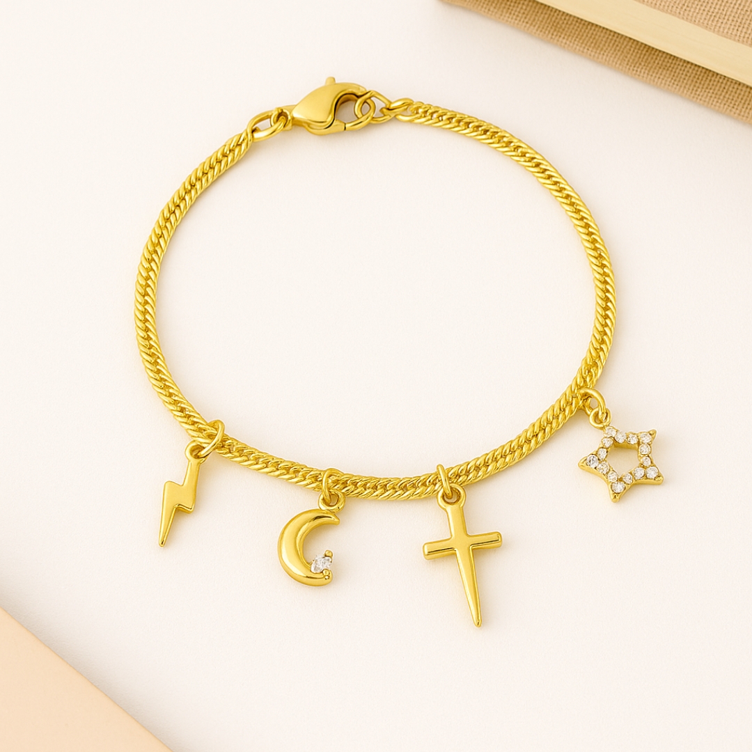Gold charm bracelet with cross, star, moon, and lightning pendant on white background – elegant handmade jewelry